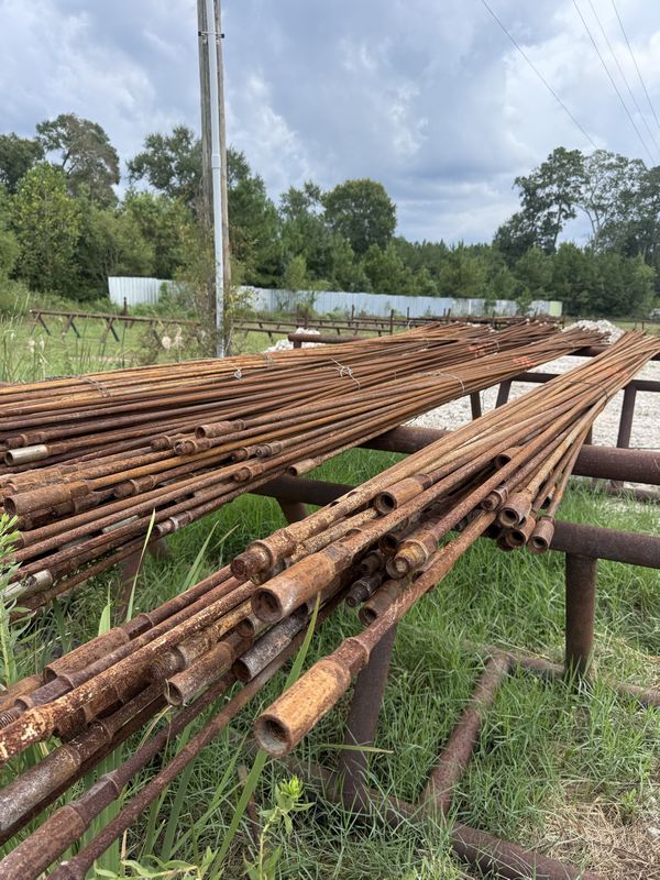 a collection of used sucker rods Gulf Coast Metal Buyers pipe yard near Houston, TX